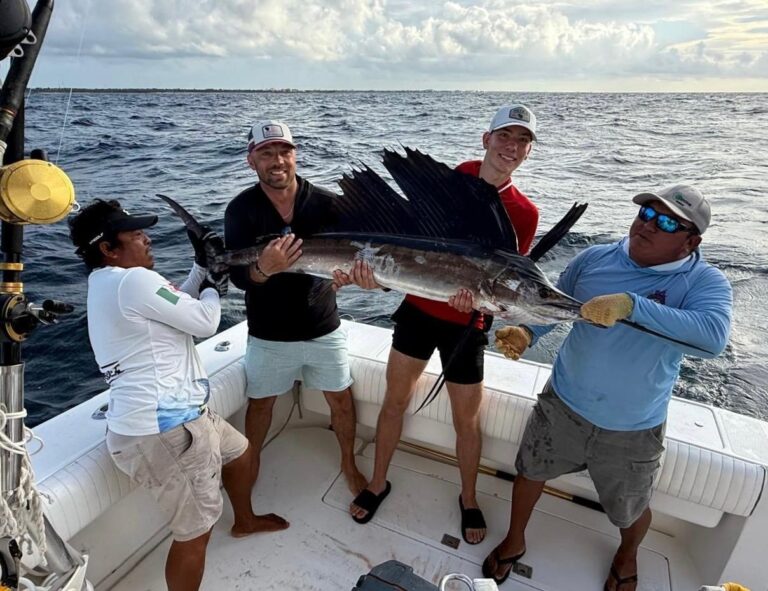 Guests and crew with an Atlantic sailfish caught on a 6-hour private charter, Puerto Aventuras, Riviera Maya